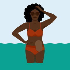 Black woman with colostomy bag on sea holiday - 552628225