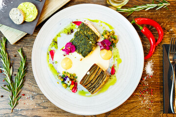 Pike-perch fillet. Potato gratin, warm yellow beet-turkey bean salad, parmesan dressing. Delicious seafood fish closeup served on a table for lunch in modern cuisine gourmet restaurant