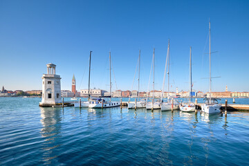 Marina and lighthouse tower on San Giorgio di Maggiore with city of Venice behind. Venezia, Italy,...