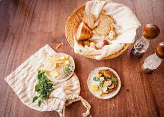  healthy vegan breakfast textures - flat lay food photo on a wooden table of vegan croissants with fresh herbs, lemon and salt