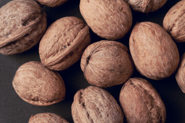 Walnuts with and without shells as background.