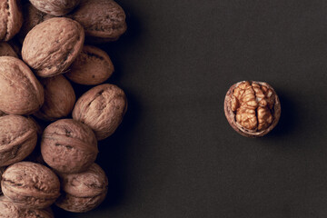 Walnuts with and without shells as background.