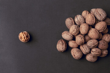 Walnuts with and without shells as background.