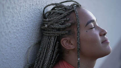 One meditative black woman closing eyes in contemplation. Female person in meditation. Profile face closeup