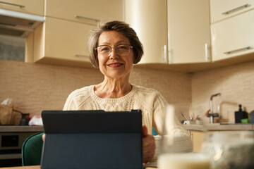 Old female surf the internet, making online purchases