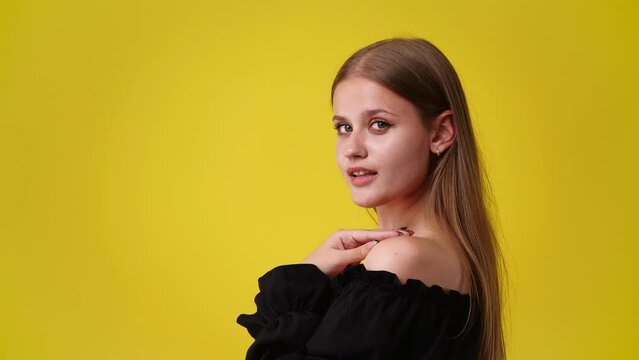 4k video of cute girl posing for a video on yellow background.