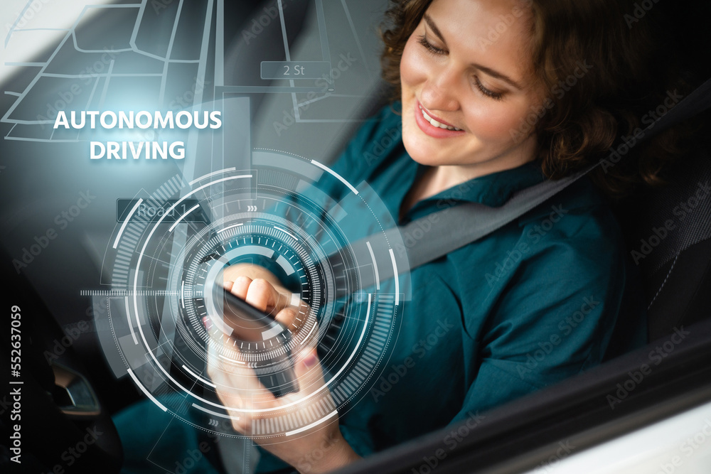 Poster woman driver controls an autonomous car using a smartphone