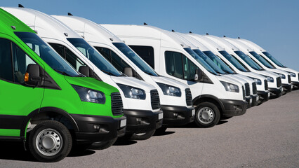 Delivery vans in a row. One van green. Clean transportation concept	