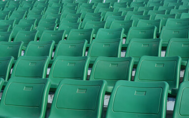 Green chair on stadium.  To watch a sporting event.