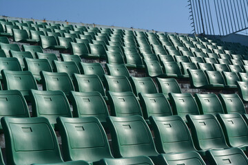 Green chair on stadium.  To watch a sporting event.