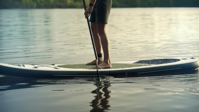 Man sup surfing . Inflatable board for rowing . 