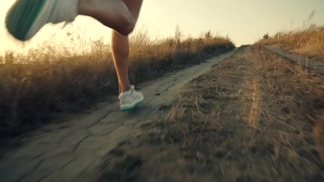 runner running along dirt road