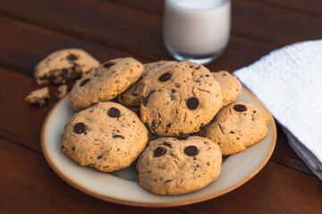 Cookies on a wooden table. After-school snack with a glass of milk