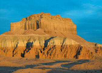 Morning light on large desert butte at Goblin Valley State Park, Utah