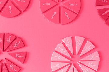 Fractions on magenta background. Back to school, fun education concept. close up. Viva magenta...