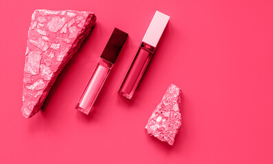 Lipsticks on abstract magenta background. Cosmetics, beauty concept. Viva magenta color of the 2023 year