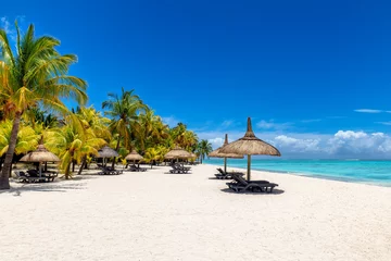 Photo sur Plexiglas Le Morne, Maurice Tropical vacations beach with palm trees and straw umbrellas and tropical sea in Paradise Mauritius island. 