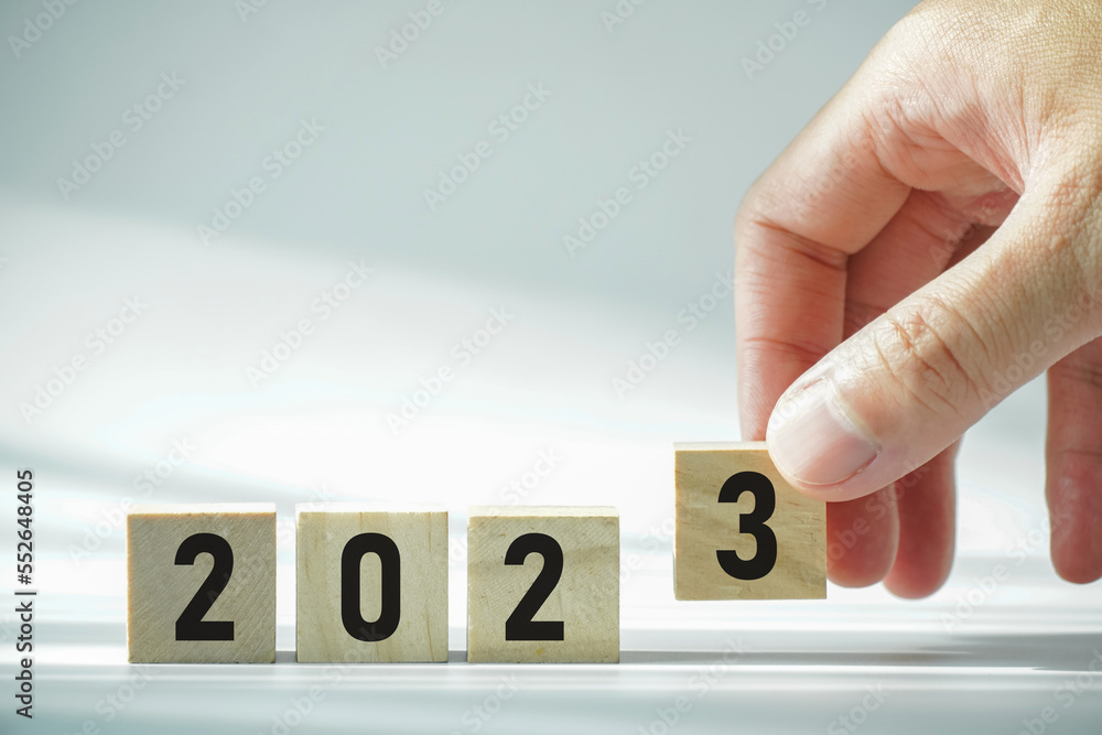 Poster concept of go to the next year 2023, people handle wooden box for change number of the year.