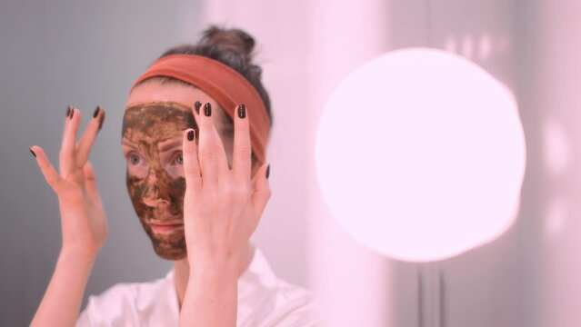 Woman cosmetic facial skin care. Woman in skin rubber peeling face beauty mask.