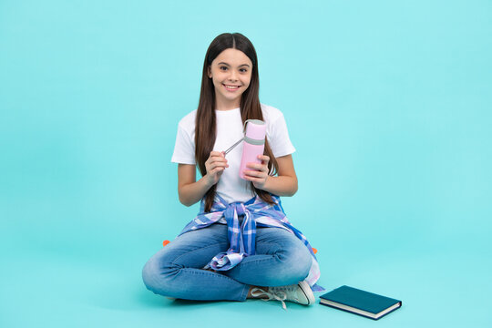 12, 13, 14 Year Old Girl Holds Thermos And Mug Of Hot Tea. Happy Teenager, Positive And Smiling Emotions Of Teen Girl.