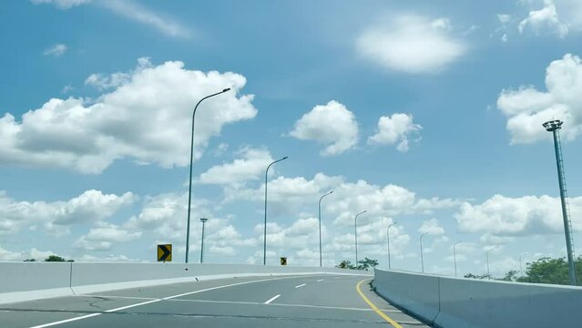 Driving along the highway road or toll road infrastructure with blue sky and white cloud