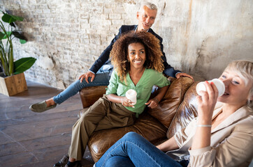 Group of  multicultural creative people having coffee break in office after meeting.