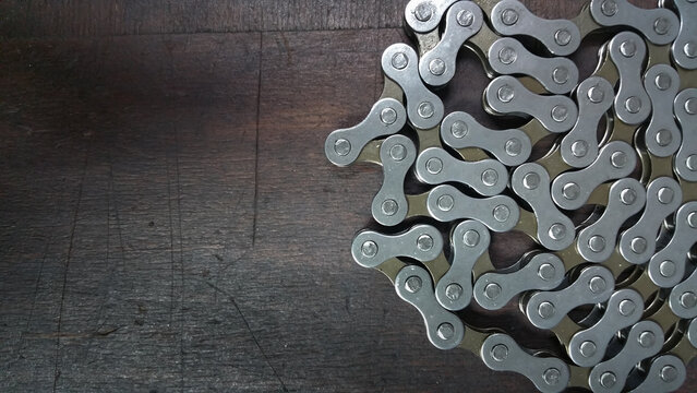 photo - bike chain - bicycle parts close up on a dark wood background
