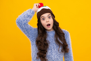 School girl in winter clothes and warm hat. Winter holiday vacation. Child fashion model. Shocked...