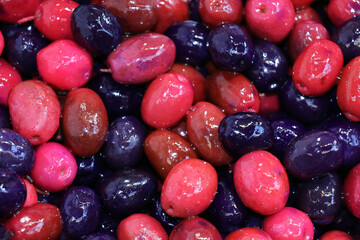 selective focus: olives flavored with forest fruits, colorful flavored olives