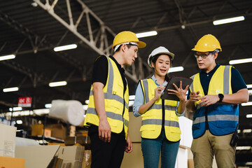Group of Asian industrial worker has meeting to brainstorm and discuss at warehouse factory workplace. Industrial worker has planning and discussing scene. Auditor working onsite.