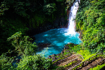 Naklejka na ściany i meble panorama of the famous rio celeste waterfall in volcano tenorio national park in costa rica; a blue waterfall in a tropical rainforest