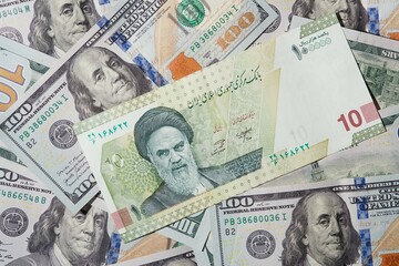 American dollars and Iranian rials background.