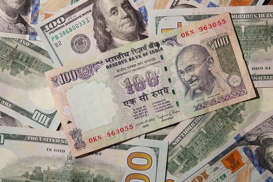 US Dollars and India Rupee banknotes close up image. Exchange rate, US dollar and India rupee 