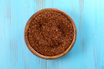 Rooibos tea in bowl. Flat lay, top view. Natural ingredients of Rooibos tea.