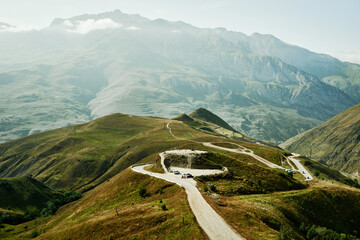 Panoramic view from above on curved road and observation deck in mountains. North Ossetia, Russia.