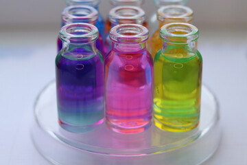 Glass jars with colored aqueous solutions of various organic dyes.