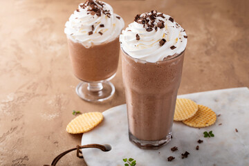 Coffee frappe topped with whipped cream and chocolate curls