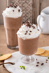 Coffee frappe topped with whipped cream and chocolate curls