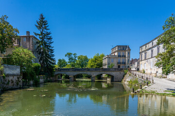 Fototapeta na wymiar A town view of a river in the French city of Jonzac