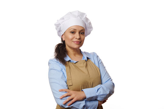 Beautiful young brunette pastry chef woman cooking pastries at the