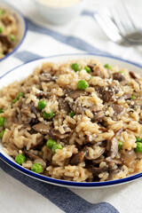 Homemade Mushroom Risotto with Peas on a Plate, side view. Close-up.