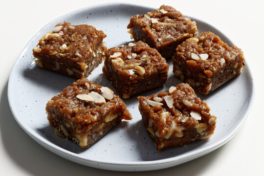 Dodha Burfi dessert with almonds on a plate. Traditional Indian fudge.