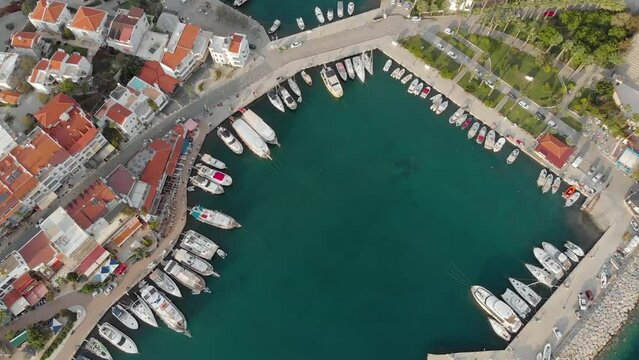 Aerial view of the city bay with moored yachts. Top view. Datca, Turkey. Azure closed bay in the center of the old city.
