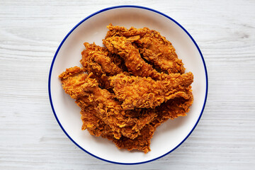 Homemade Chicken Strips with Mustard and BBQ on a Plate, top view. Flat lay, overhead, from above.