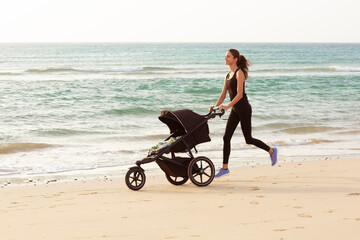 Beautiful mom and son doing a morning jogging on the beach.