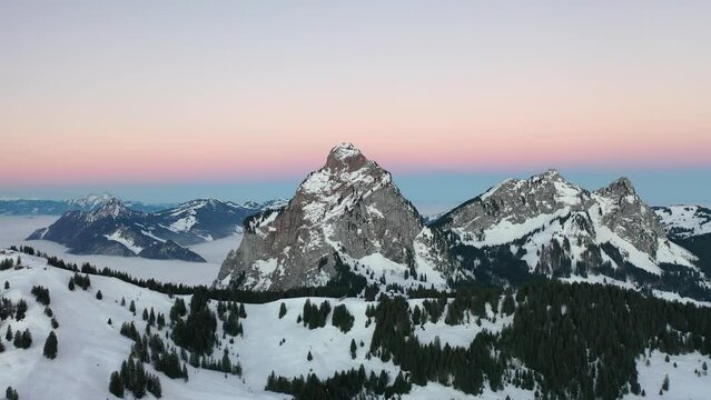 Insane scenery in the middle of Switzerland in the canton of Schwyz. This beautiful aerial view was captured with a DJI drone. Epic sunrise with a beautiful pink sky on the horizon.