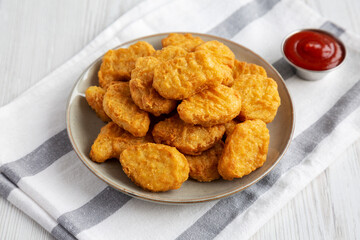Homemade Chicken Nuggets with Ketchup, side view.