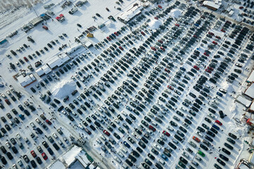 Aerial view of many cars parked for sale and people customers walking on car market or parking lot...