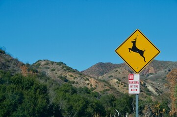 Deer crossing sign Malibu hills California blue sky