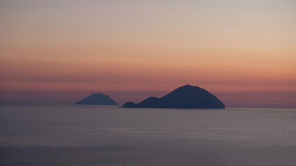 Fototapeta na wymiar Aeolian Islands, Sicily. At sunset, the silhouettes of Filicudi and Alicudi islands, from Salina island.